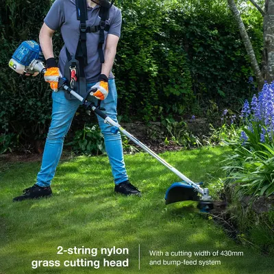 Demonstrates the grass cutting head in use and communicates its wide cutting width and easy bump feed. States the cutting width dimension of the grass trimmer head.