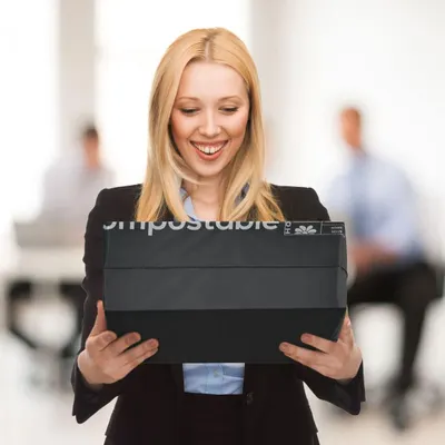 Shows a smiling person receiving a package in a professional setting to convey a positive shipping experience.