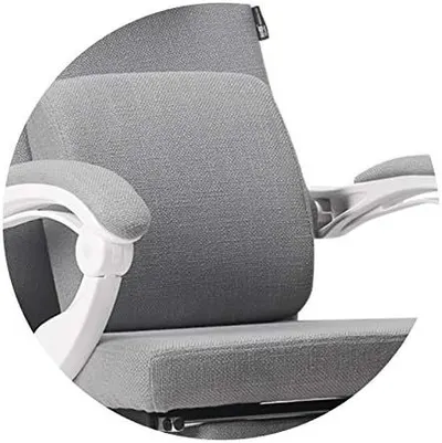 Close-up zoom of the fabric backrest and armrest to convey soft, supportive material quality.