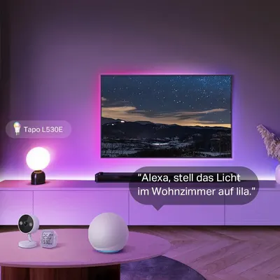 Shows the bulb working alongside other smart home devices and voice control to set room ambience. Highlights that voice commands can set the room to a specific color.