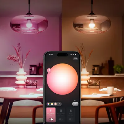Shows the bulb transforming a room between cool pink and warm amber tones, communicating one core idea that the light adapts to mood with a single smart control. Shows the Hue app color wheel…