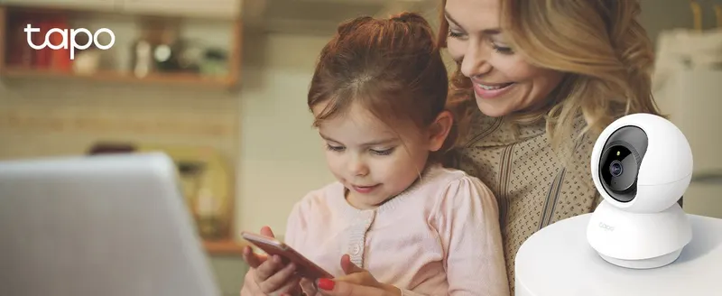 Shows a family using the camera-connected app setting to help shoppers imagine peace of mind at home.