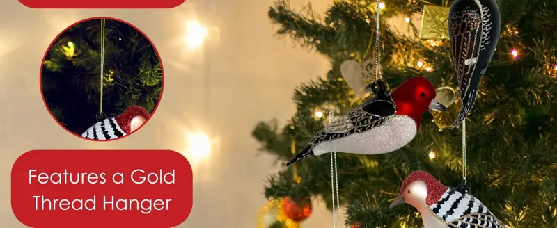 Highlights a specific product feature (gold thread hanger) in a festive Christmas tree setting to position the ornament as a holiday gift or seasonal…