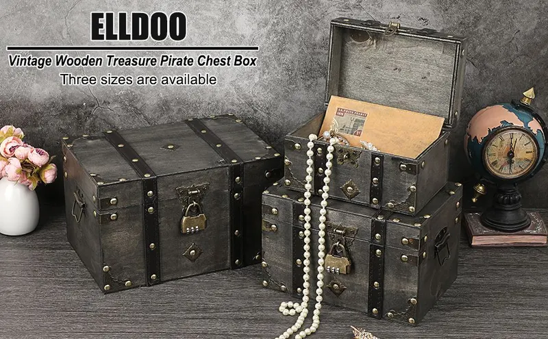 Shows the three nested vintage treasure chests styled on a rustic table with pearls, letters, and decor to help shoppers envision them as decorative storage.