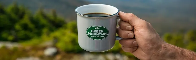 Shows the product being used in a real-world outdoor environment to help shoppers envision the coffee experience and connect with the brand lifestyle.